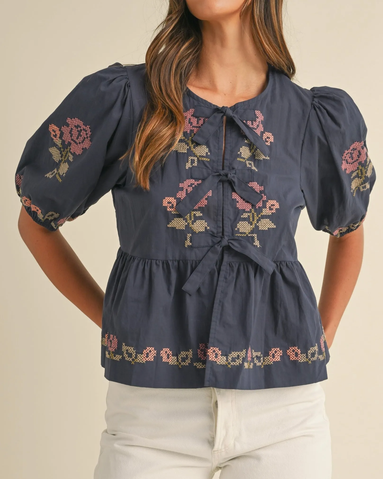 Embroidered Puff Sleeve Bottom Ruffle Front Tie Top in Navy