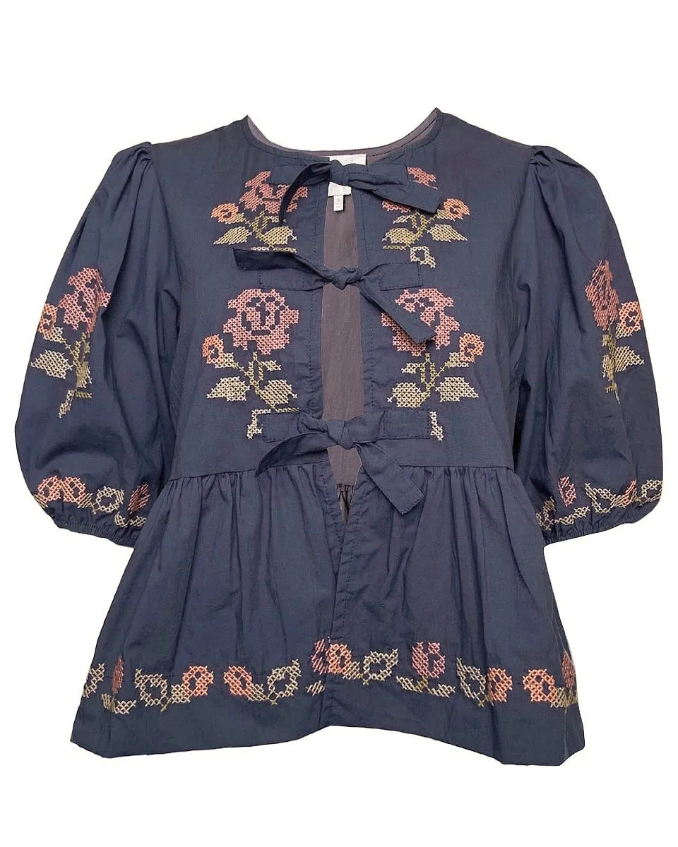 Embroidered Puff Sleeve Bottom Ruffle Front Tie Top in Navy