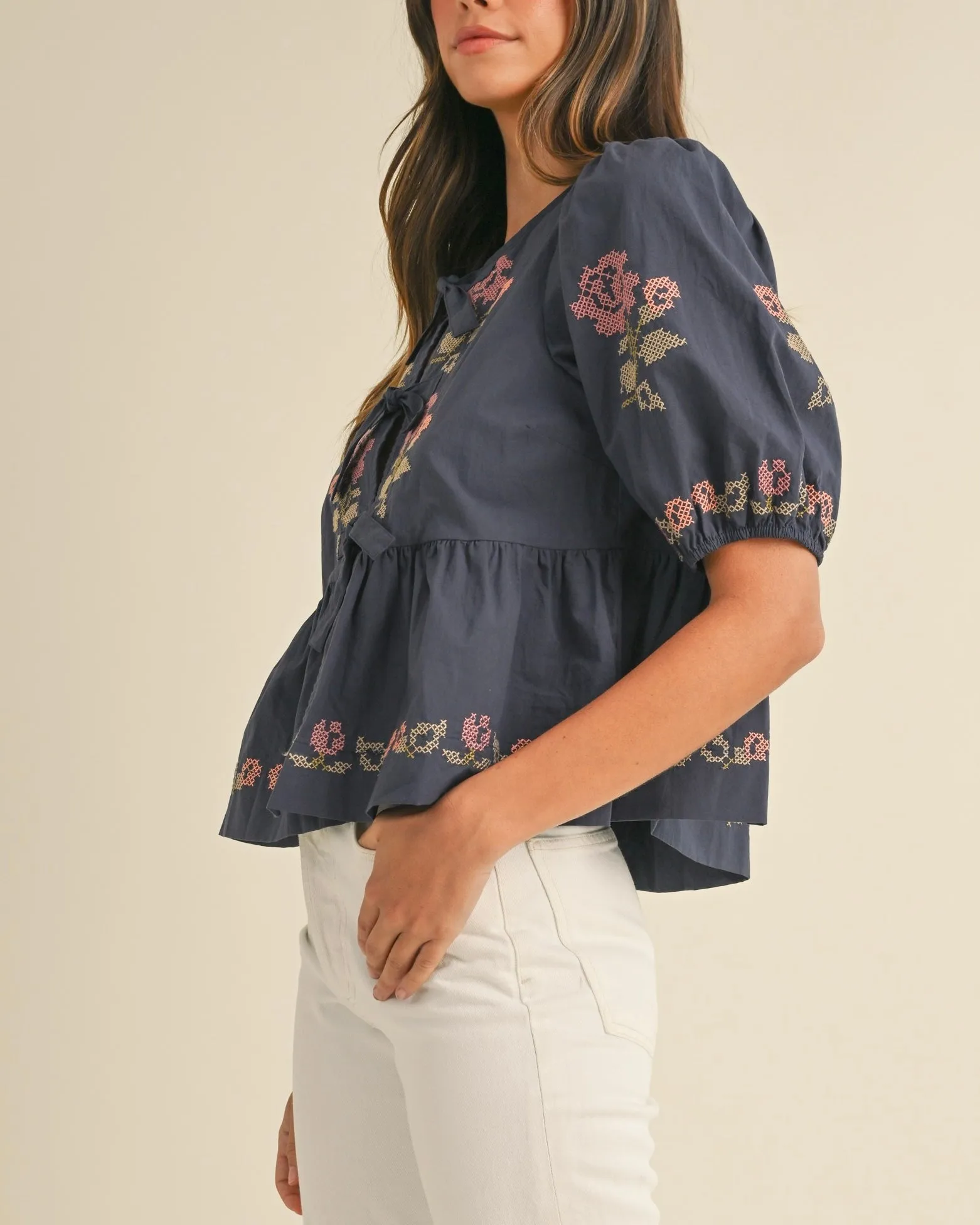 Embroidered Puff Sleeve Bottom Ruffle Front Tie Top in Navy