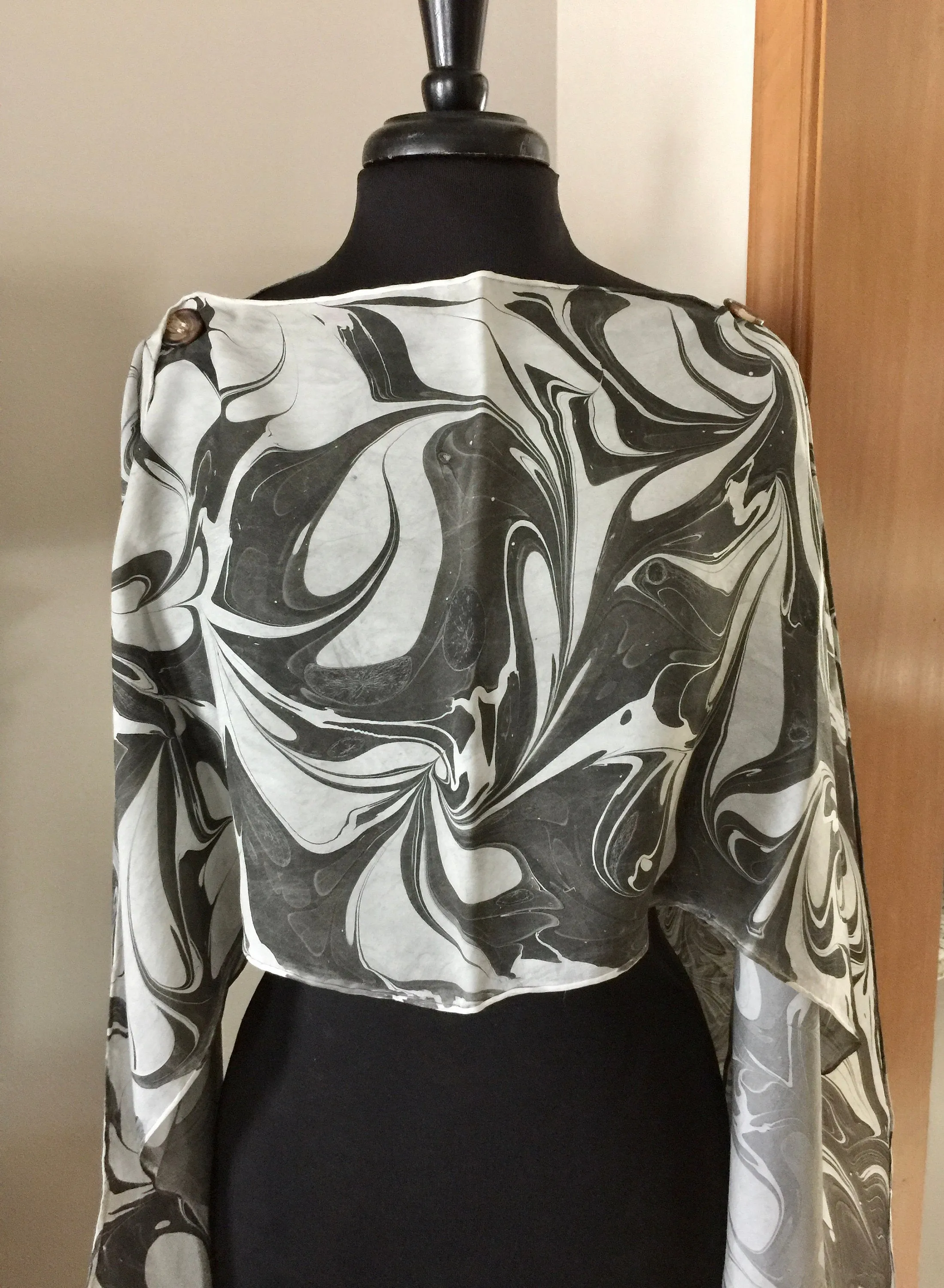The Shibumi.  It’s a wrap, a shawl, a fashion statement!  Wear it 10 different ways!
